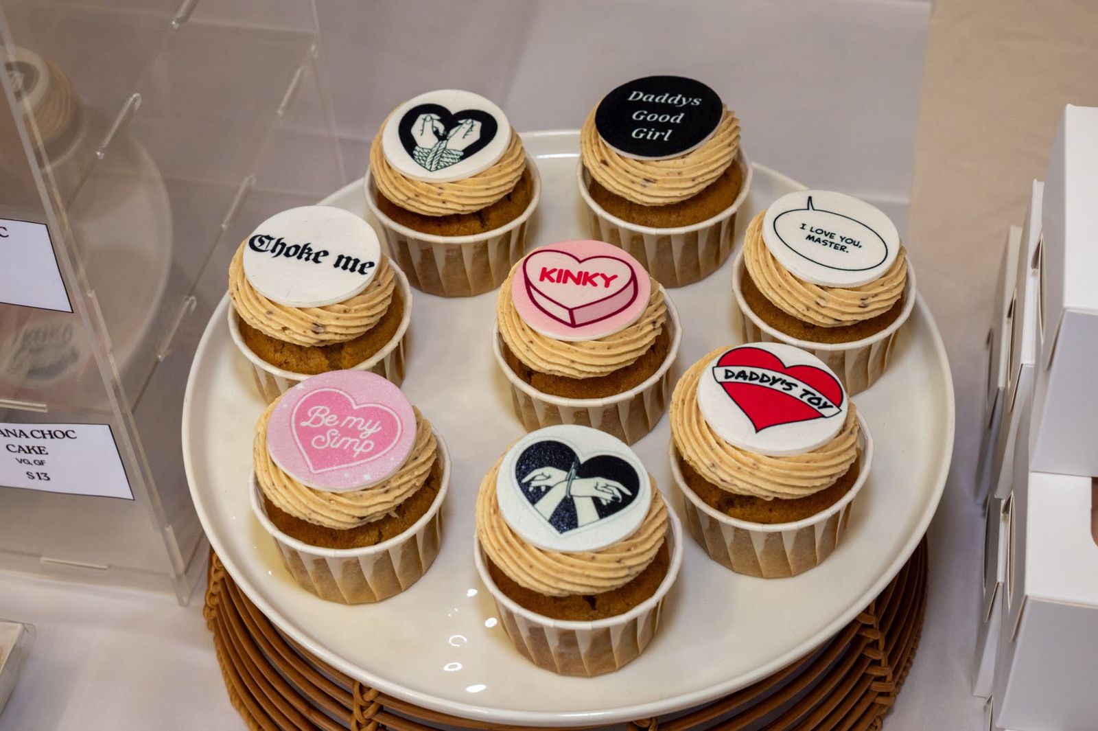 Iced cupcakes lined up on a table