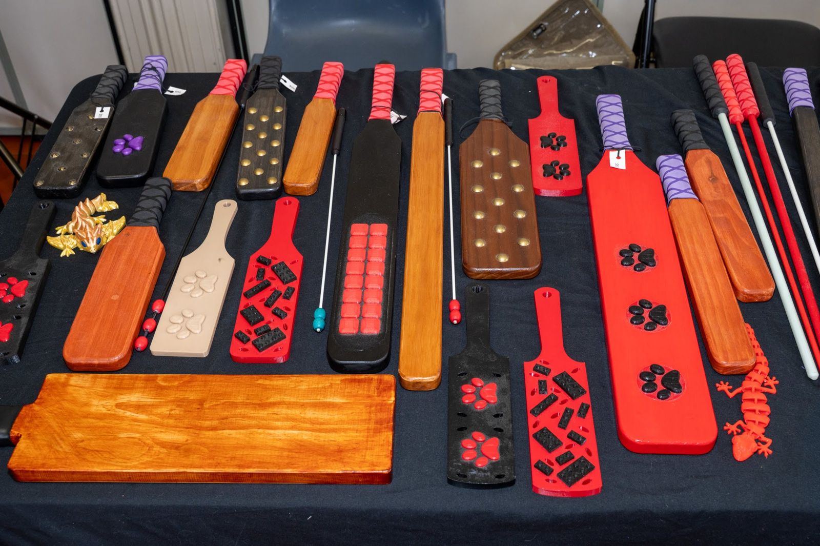 Handmade wooden paddles and play things laid out on a stall